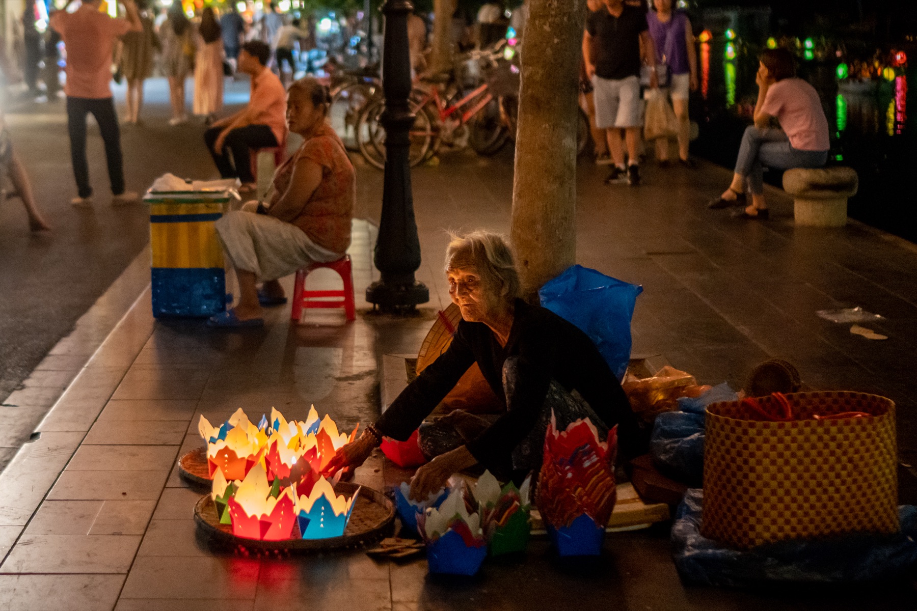 Woman selling paper lanterns at a night market in Hoi An